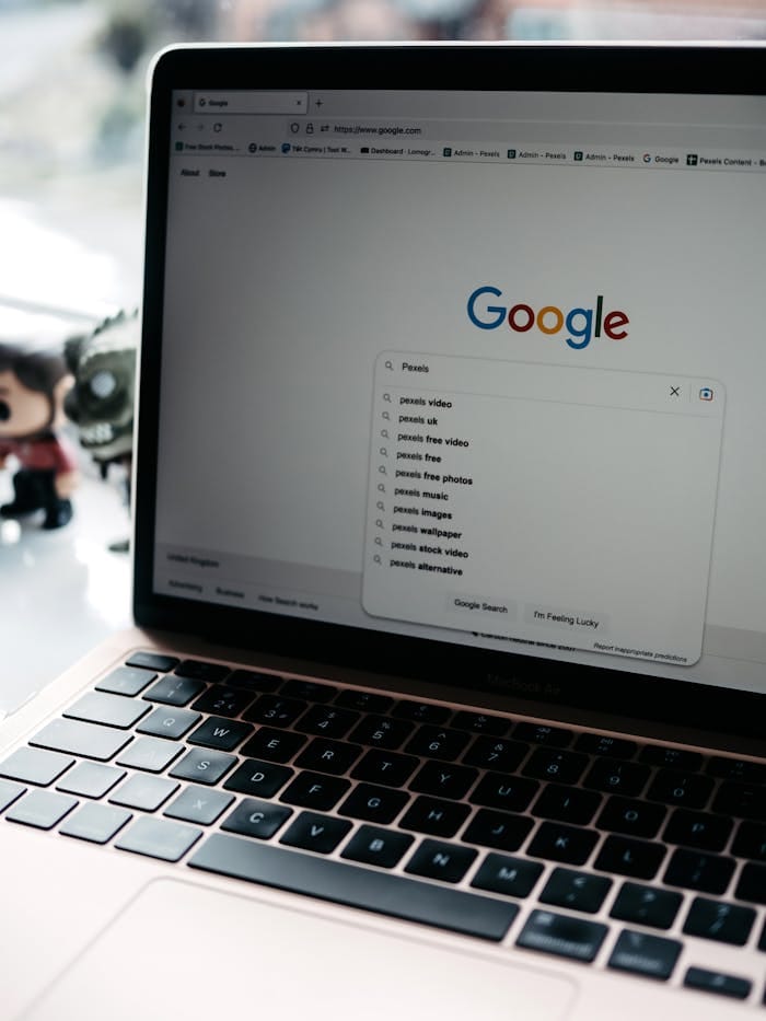 Laptop displaying Google search page with suggestions related to "Pexels," emphasizing digital marketing and online visibility for healthcare practices.
